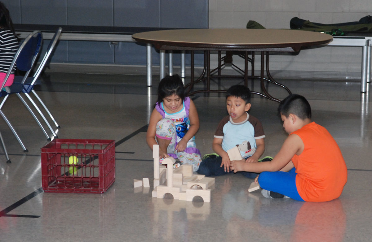 Evacuated children playing on floor